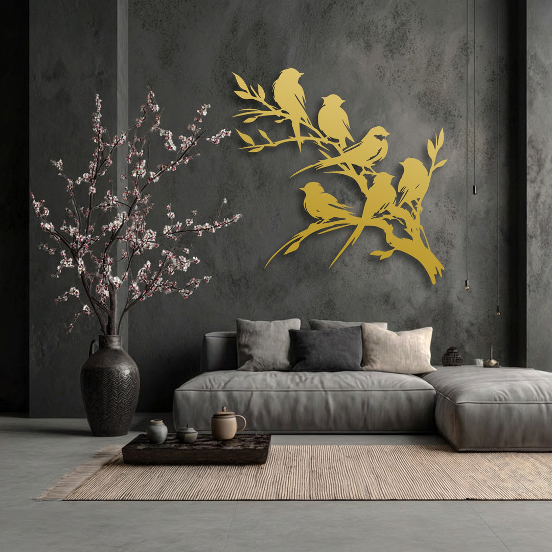 The visual rhythm of the elegant golden birds on branch metal artwork creates a harmonious flow against the dark wall, complementing the delicate blossoms.