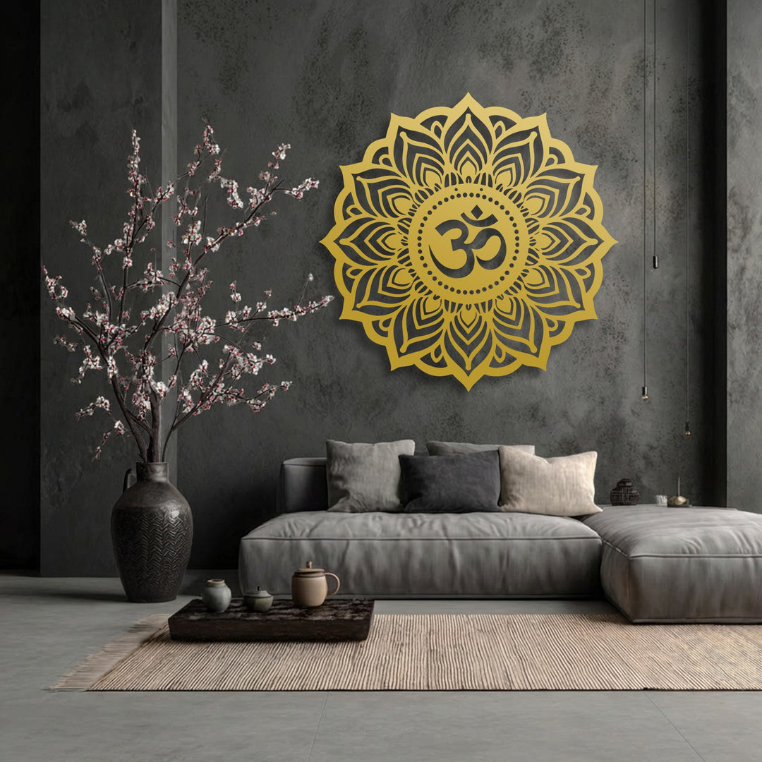 Dramatic color contrast illuminates the vibrant gold Sacred Om Mandala metal art for wall against the dark gray backdrop, with cherry blossoms.