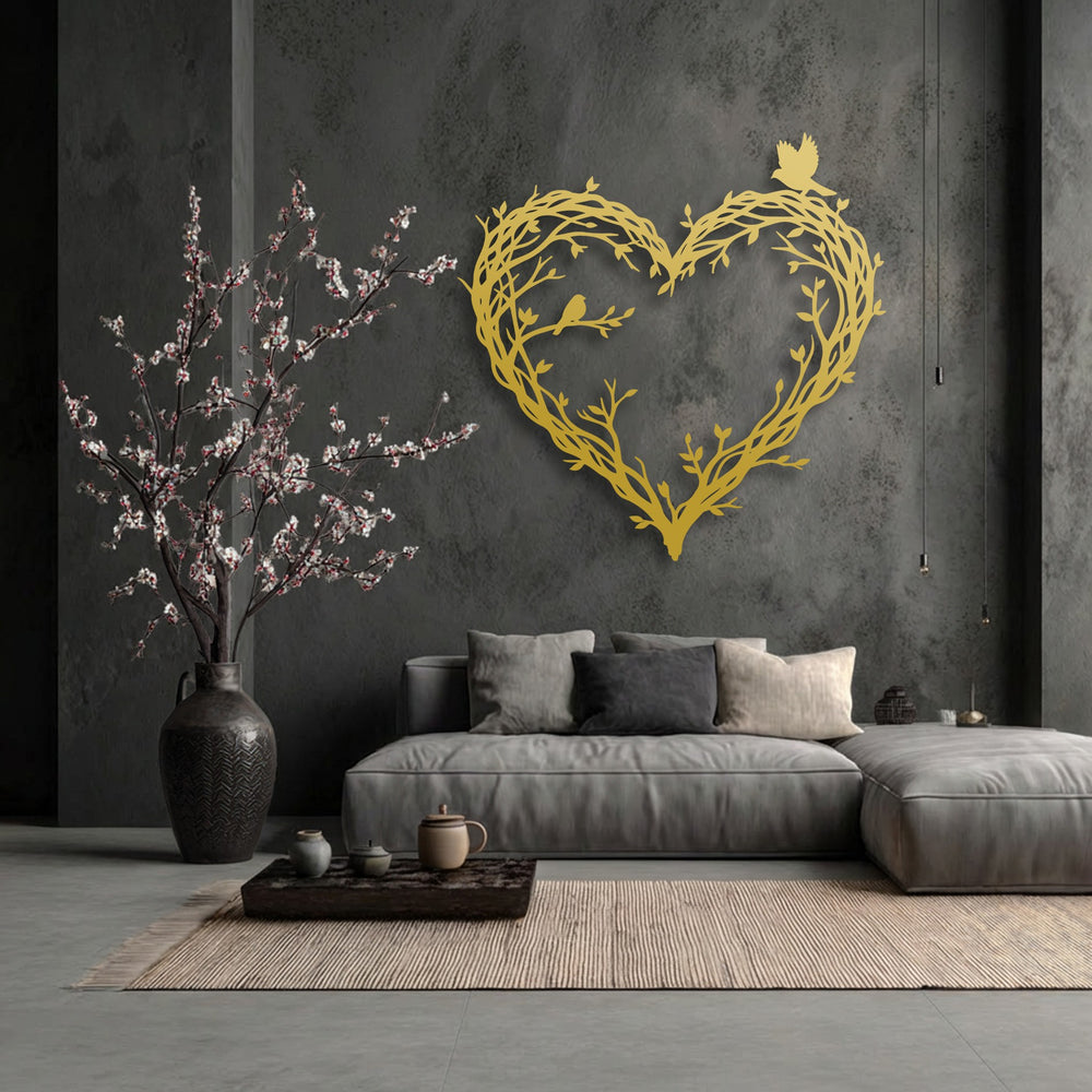 The darkest area, a deep charcoal wall, dramatically highlights the golden bird and branch heart metal decoration wall art.