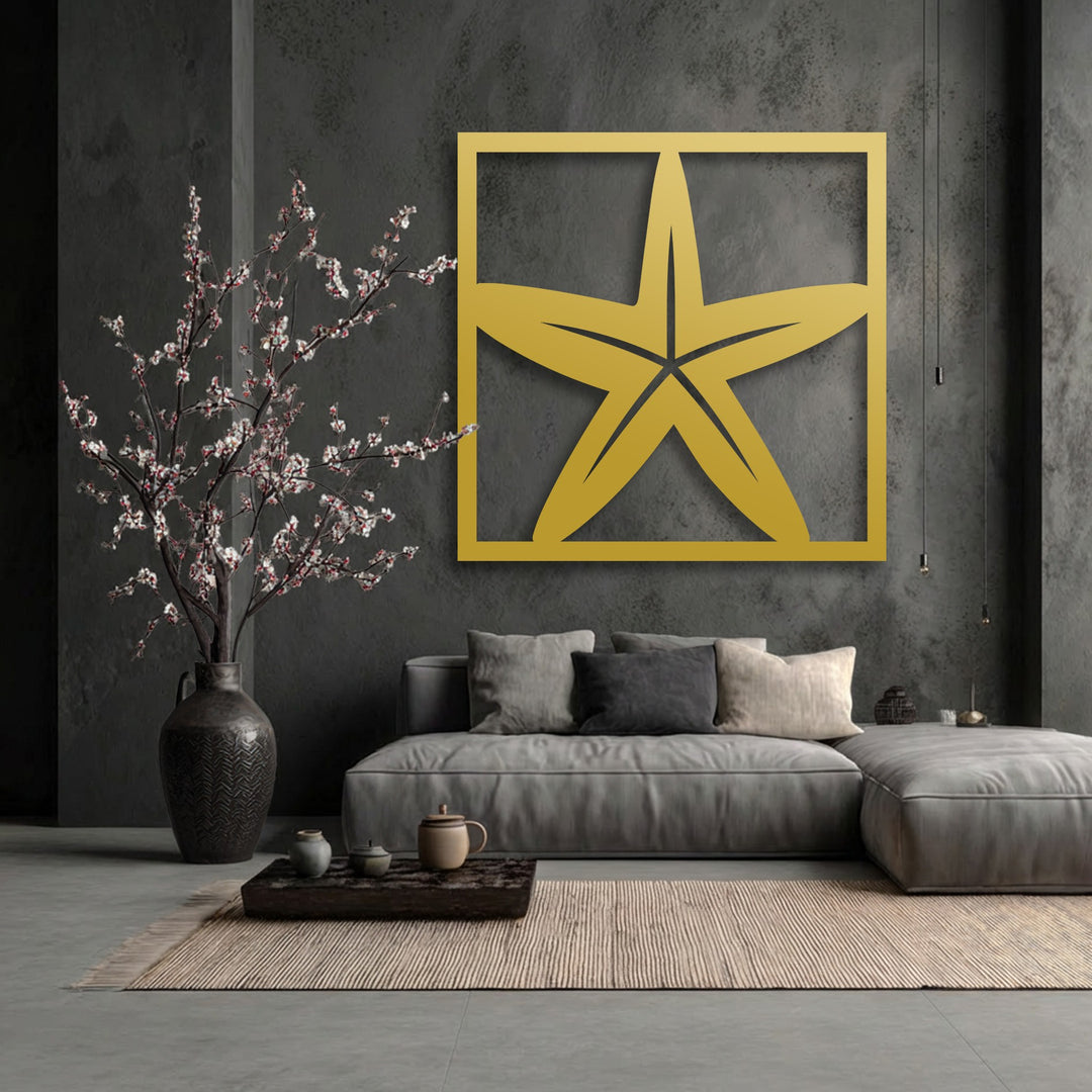 The brightest area highlights the vibrant golden starfish frame of this Coastal Star decorative metal art, beautifully contrasting the dark wall.