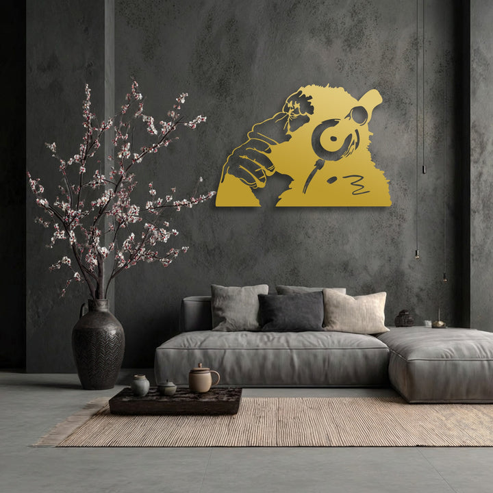 Soft light and deep shadows define this urban monkey headphones metal wall decor, creating a dramatic contrast on the textured dark wall.