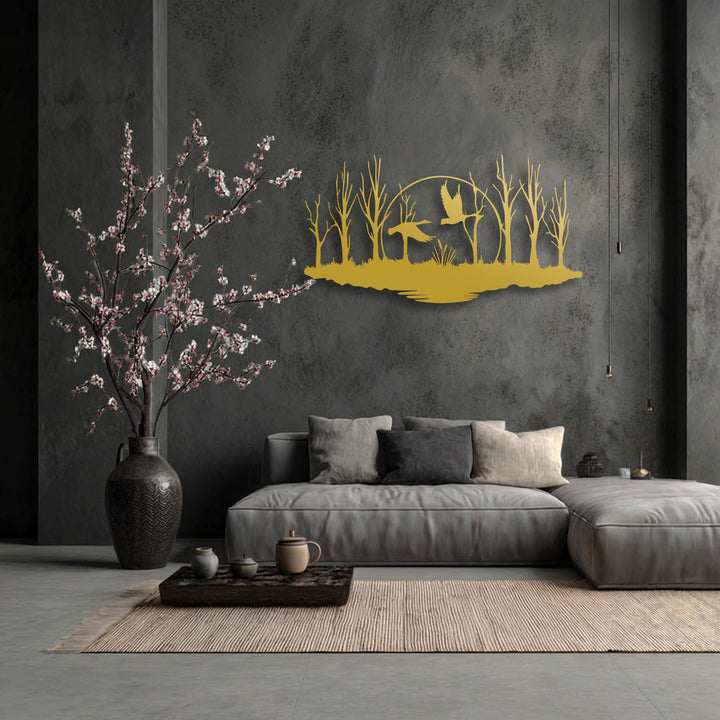 The organic forms of the golden flying birds and forest silhouette metal artwork elegantly adorn a dark textured wall, creating a serene natural vista.