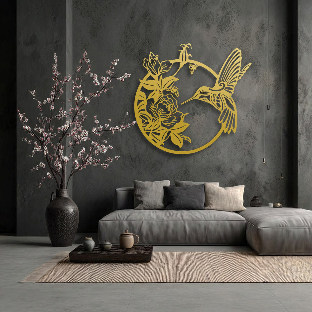The brightest area highlights the radiant gold metal decoration wall art featuring a graceful hummingbird with blooming flowers.