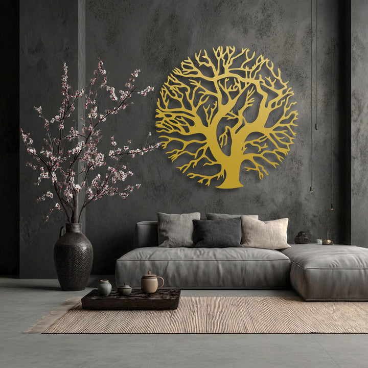 The radiant golden Tree of Life metal wall decor, intricately designed in a circular silhouette, stands out as the brightest area.