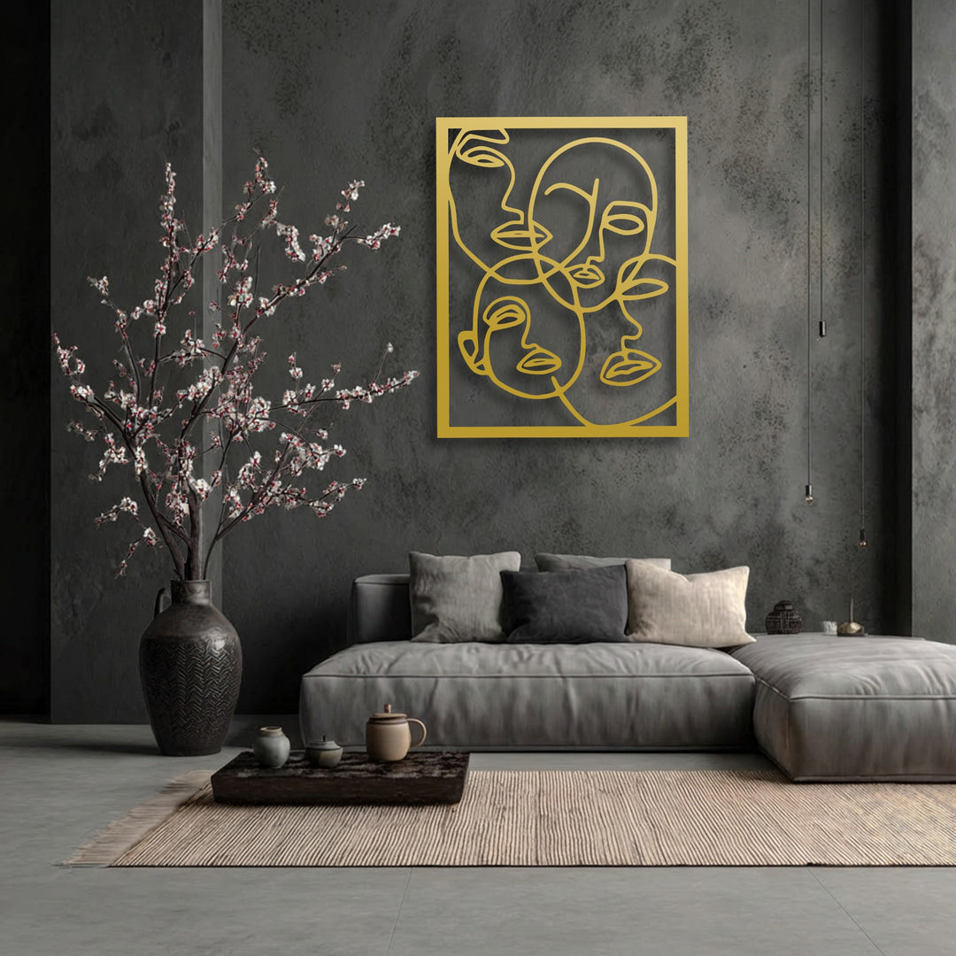 The radiant gold finish of the Abstract Faces Line Art decorative metal art gleams on the dark wall, offering a striking contrast.