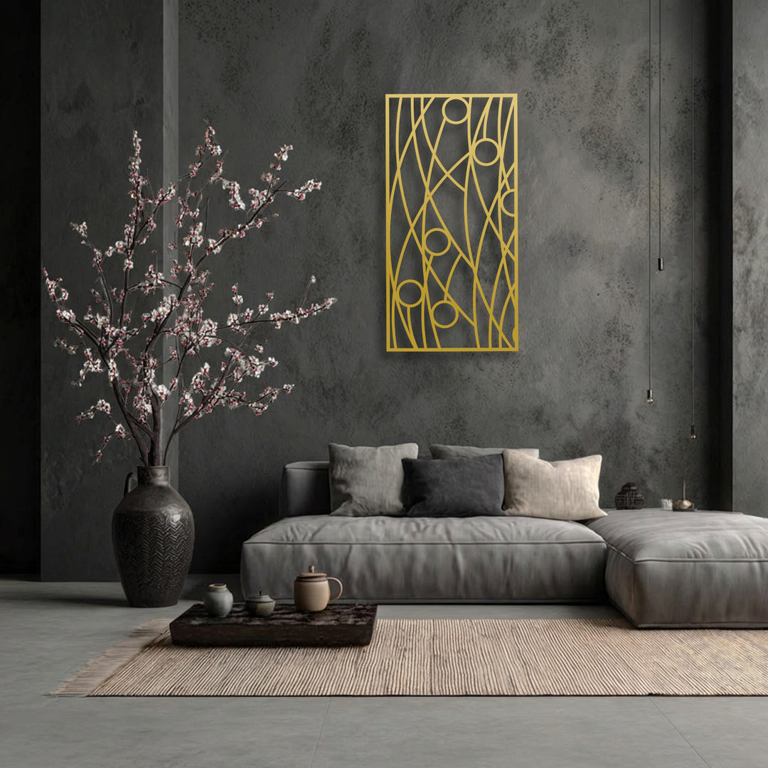 The distressed dark wall showcases a smooth, golden abstract linear geometry metal artwork, contrasting with the soft couch and ribbed rug textures.