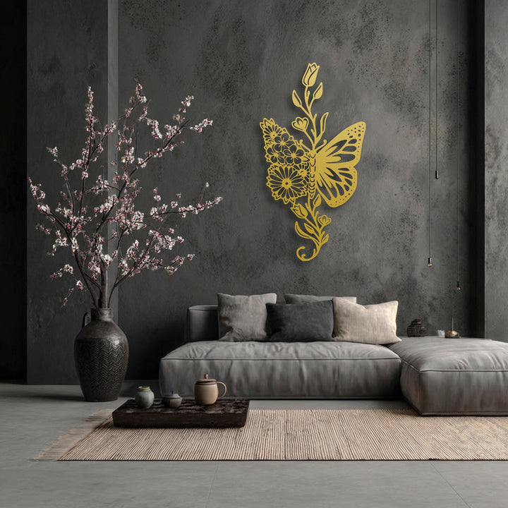 Organic forms of a golden floral butterfly metal artwork beautifully adorn a dark wall, embodying elegant nature.