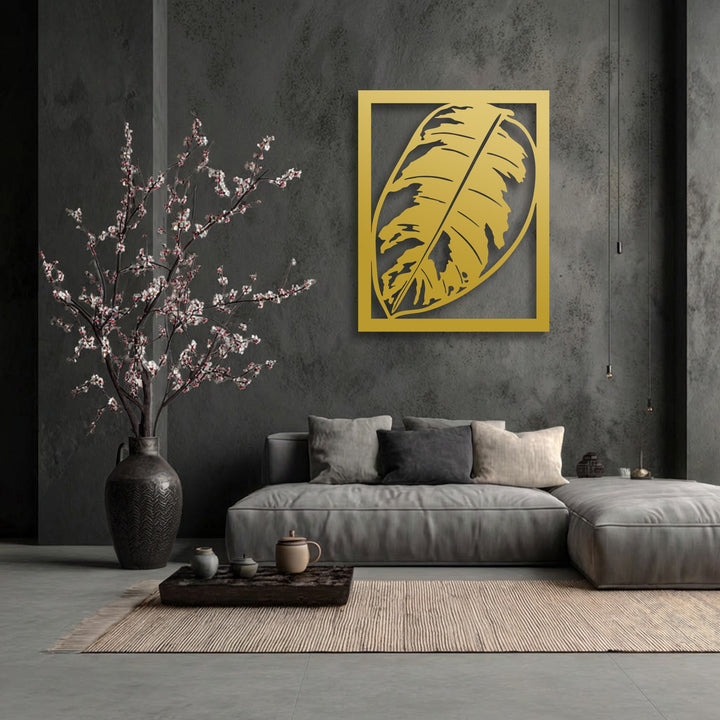 A modern interior displays a predominantly cool color temperature, softened by a vibrant golden monstera leaf metal art for wall.