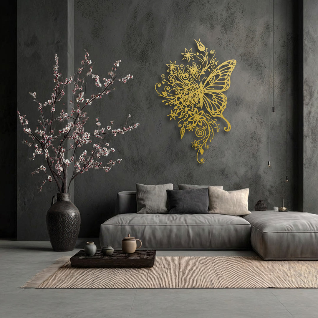 The lustrous golden finish of this ornate floral butterfly metal art for wall gleams against the dark, textured wall.