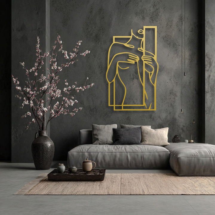 Realistic detail emphasizes the golden minimalist female figure line art, striking decorative metal art, on the dark textured wall.