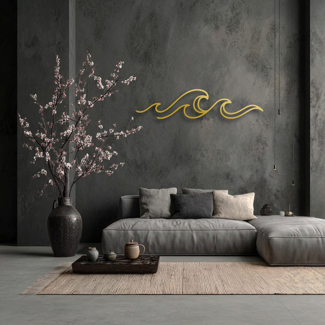 Charcoal gray textured wall features minimalist golden wave decorative metal art above a light gray sofa.