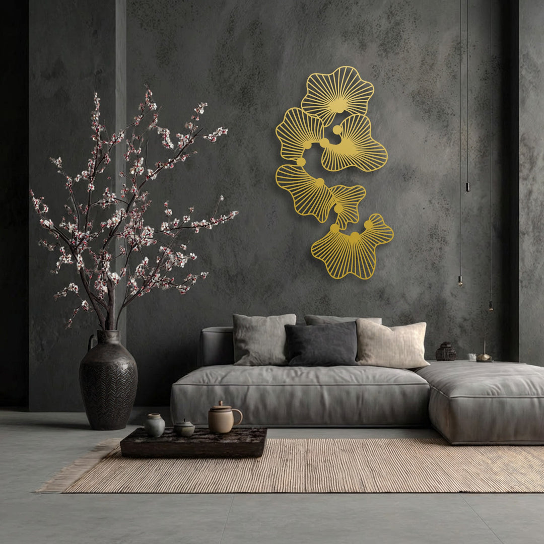 The central subject is elegant gold abstract floral decorative metal art, showcasing a modern line flower design on a dark textured wall.