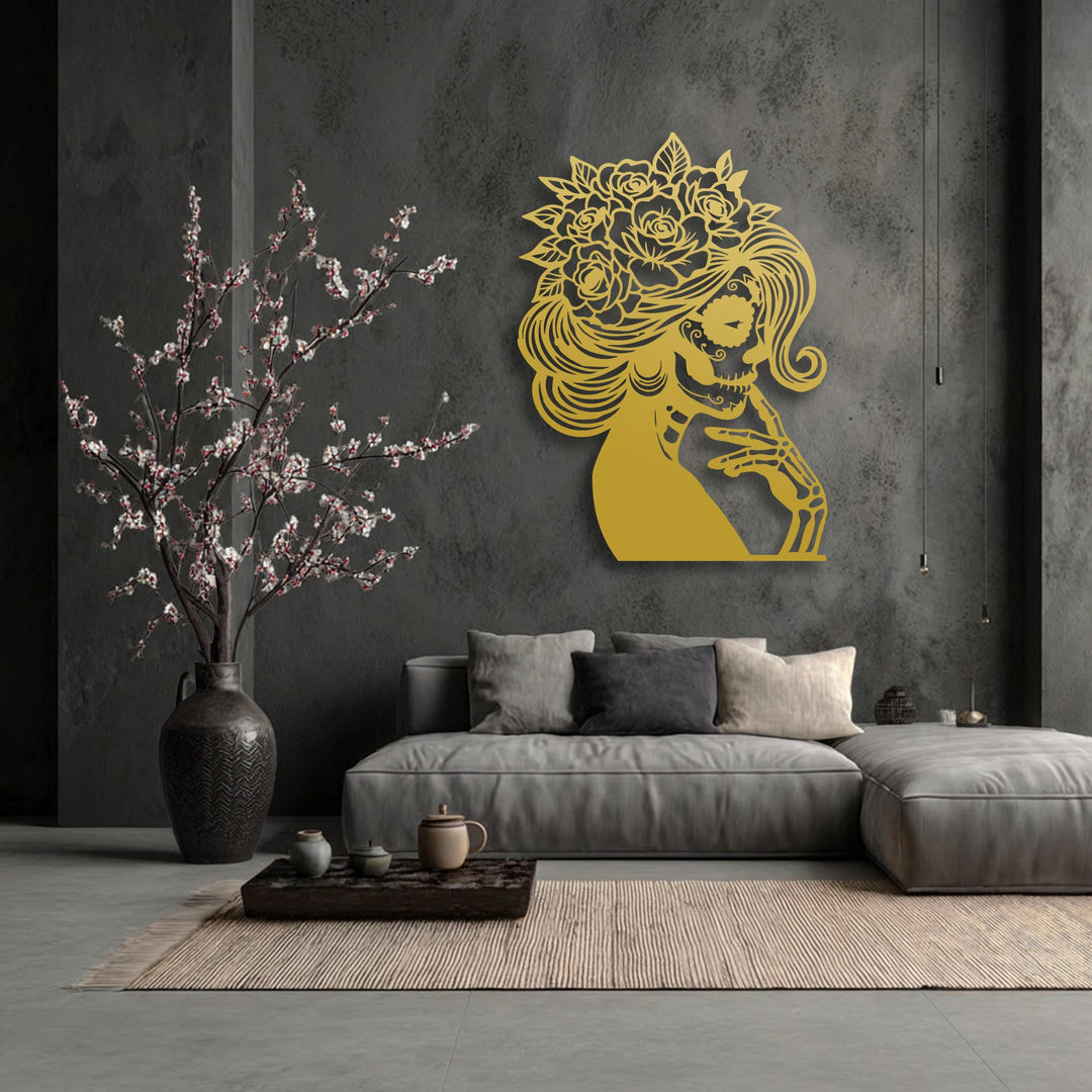 A dynamic visual rhythm emanates from the golden floral sugar skull metal artwork, complemented by the delicate, flowering branches.