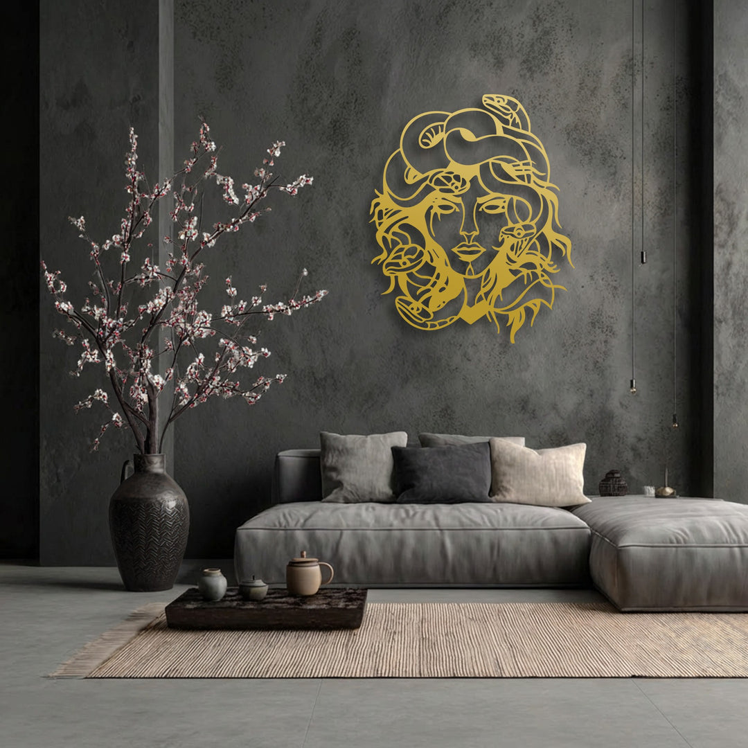 Visual rhythm emanates from the golden Medusa metal artwork, its intricate snakes flowing with the soft lines of the flowering branches and textured rug.