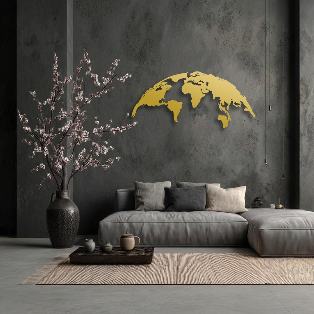A golden unique metal wall art world map with a modern global silhouette brightens a dark wall above a plush sofa.