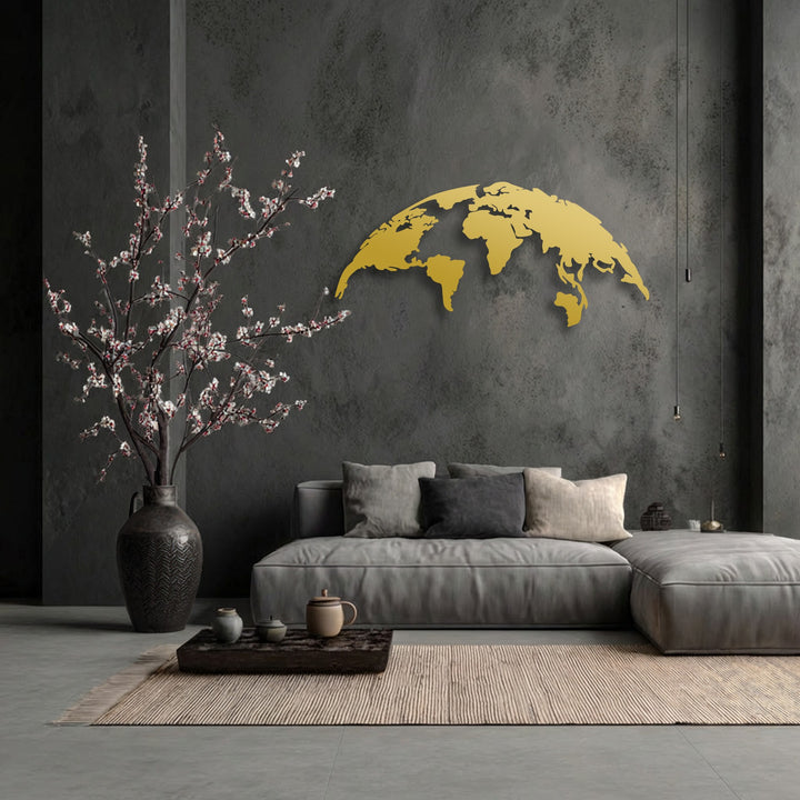A golden unique metal wall art world map with a modern global silhouette brightens a dark wall above a plush sofa.