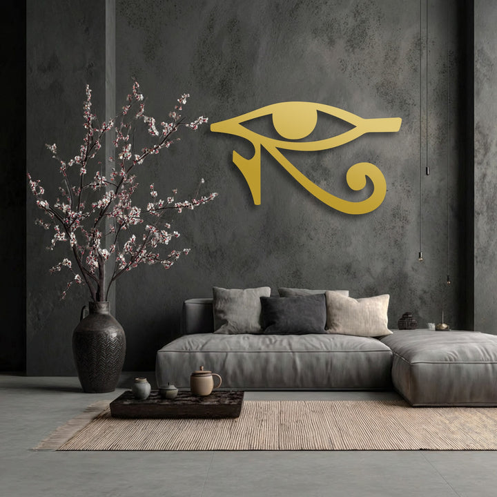 The room exudes stillness with a golden Eye of Horus metal art for wall, a minimalist sofa, and a vase of delicate blossoms.