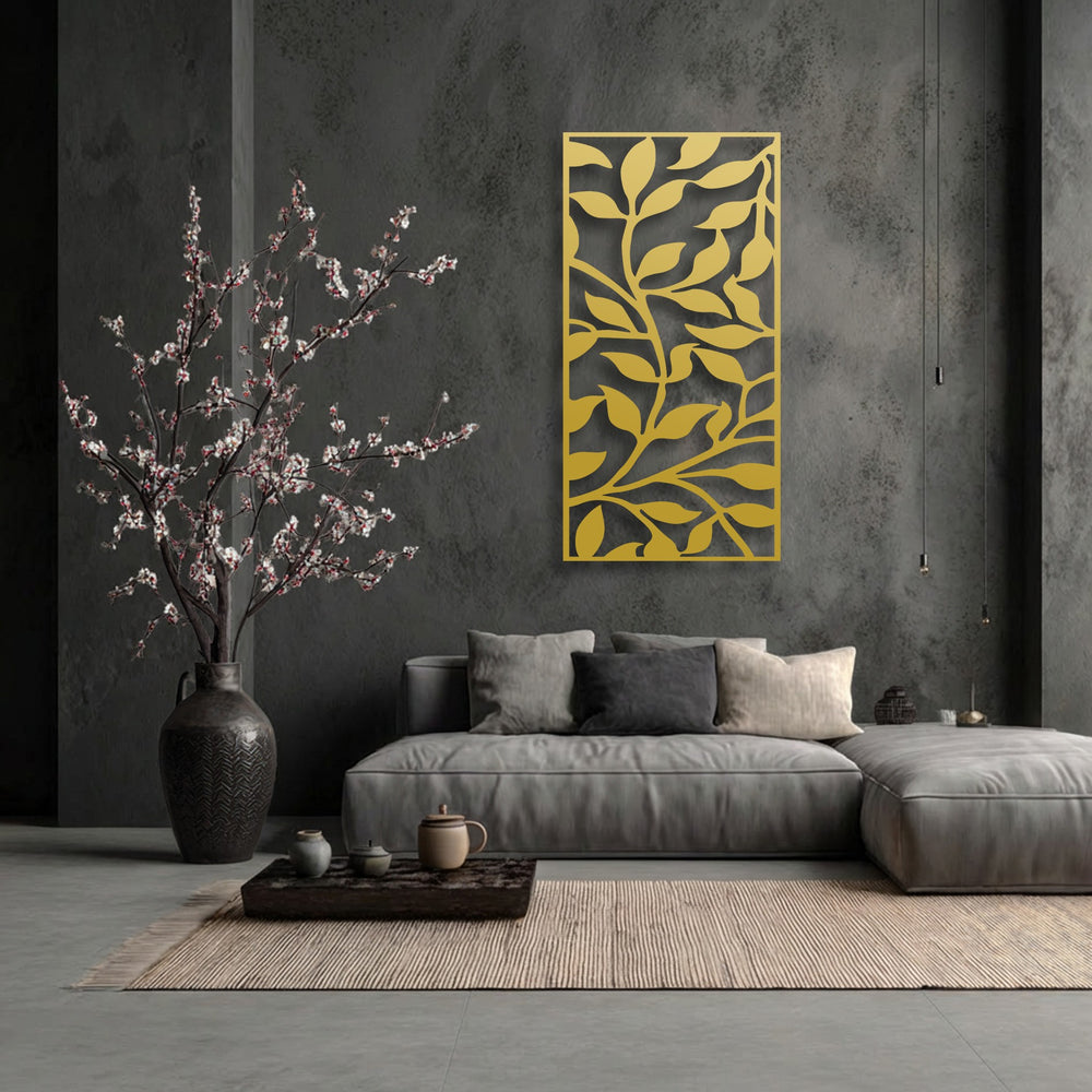 The background features a dark charcoal gray textured concrete wall, accentuating the unique metal wall art with an abstract leaf branch pattern.