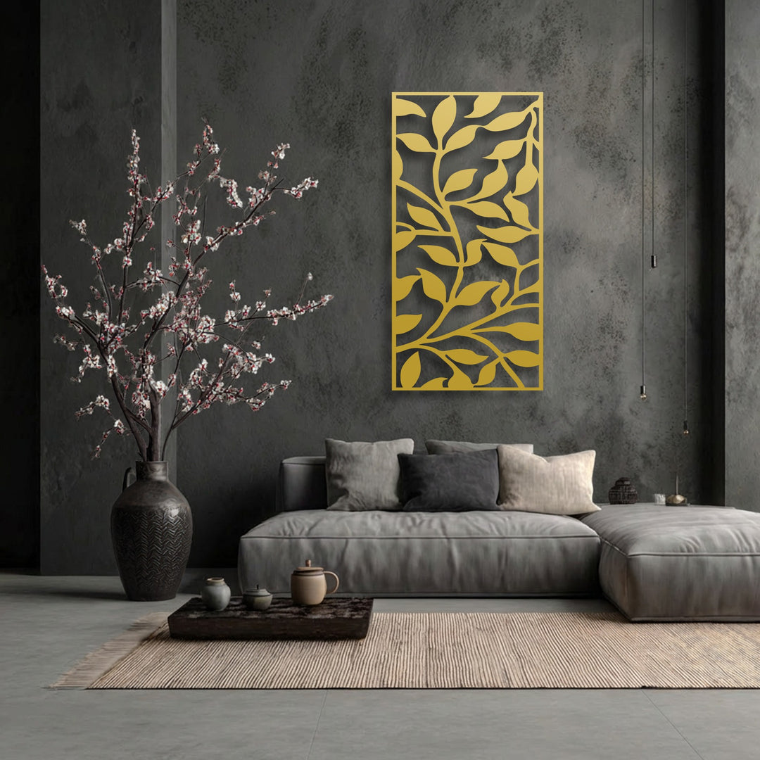 The background features a dark charcoal gray textured concrete wall, accentuating the unique metal wall art with an abstract leaf branch pattern.