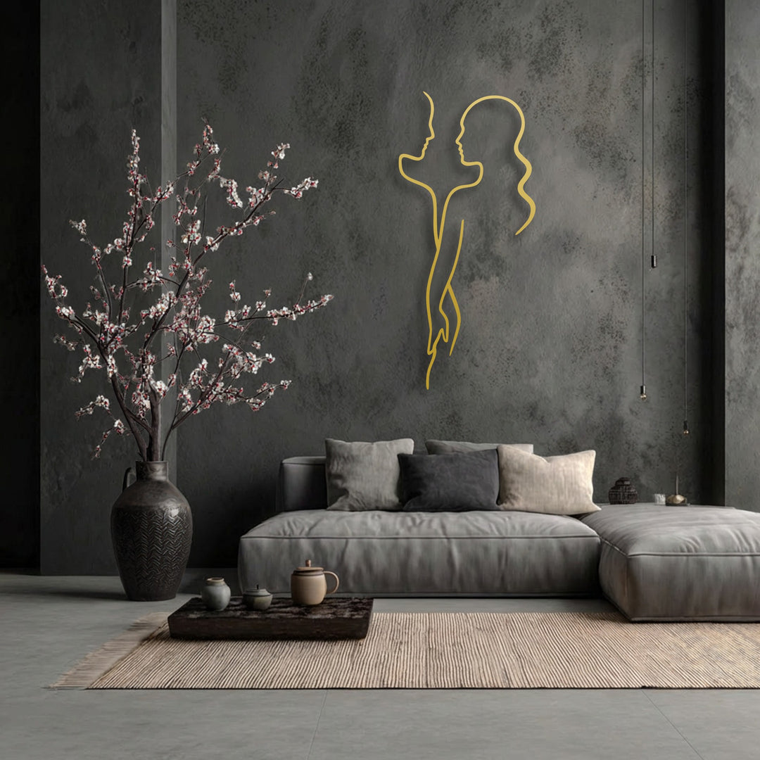 The loud golden outline of Minimal Couple Line Metal Wall Art stands as prominent metal artwork on the textured dark wall.