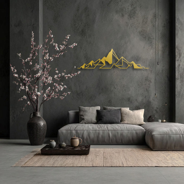 The image features a muted and desaturated color palette, highlighted by the striking gold abstract mountain line metal art for wall.