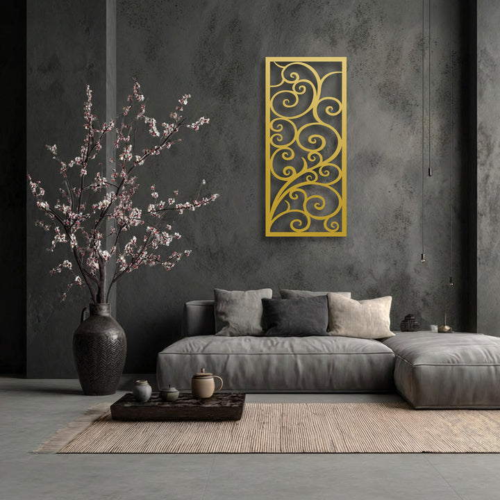 The brightest area showcases an intricate gold scroll pattern, an elegant piece of decorative metal art, beautifully contrasting against the dark wall.