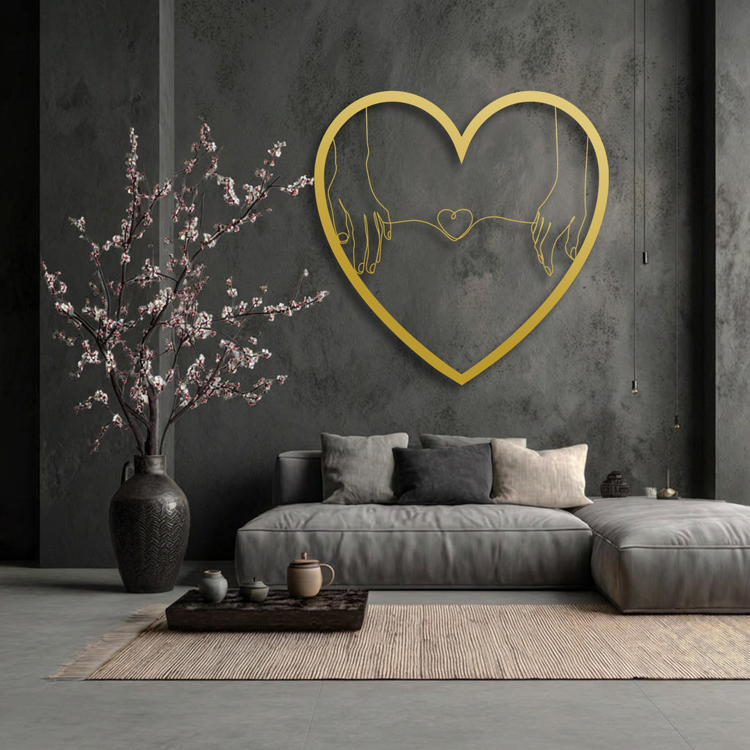 With subdued color saturation, a prominent golden heart metal wall decor featuring holding hands stands out in a monochromatic room.