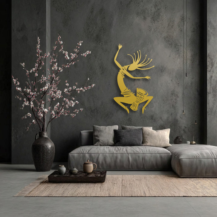 The mood of this contemporary space is vibrant and cultural, highlighted by the dynamic tribal dance silhouette metal artwork.