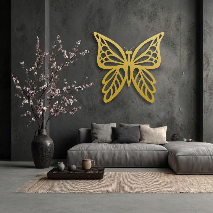 Negative space cleverly defines the elegant golden butterfly silhouette, enhancing this minimal nature metal wall decor on a textured dark wall.