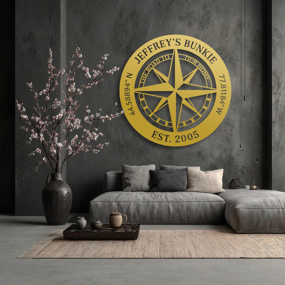 The warm color temperature of the personalized compass decorative metal art brightly contrasts with the cool, dark living space, creating an inviting glow.