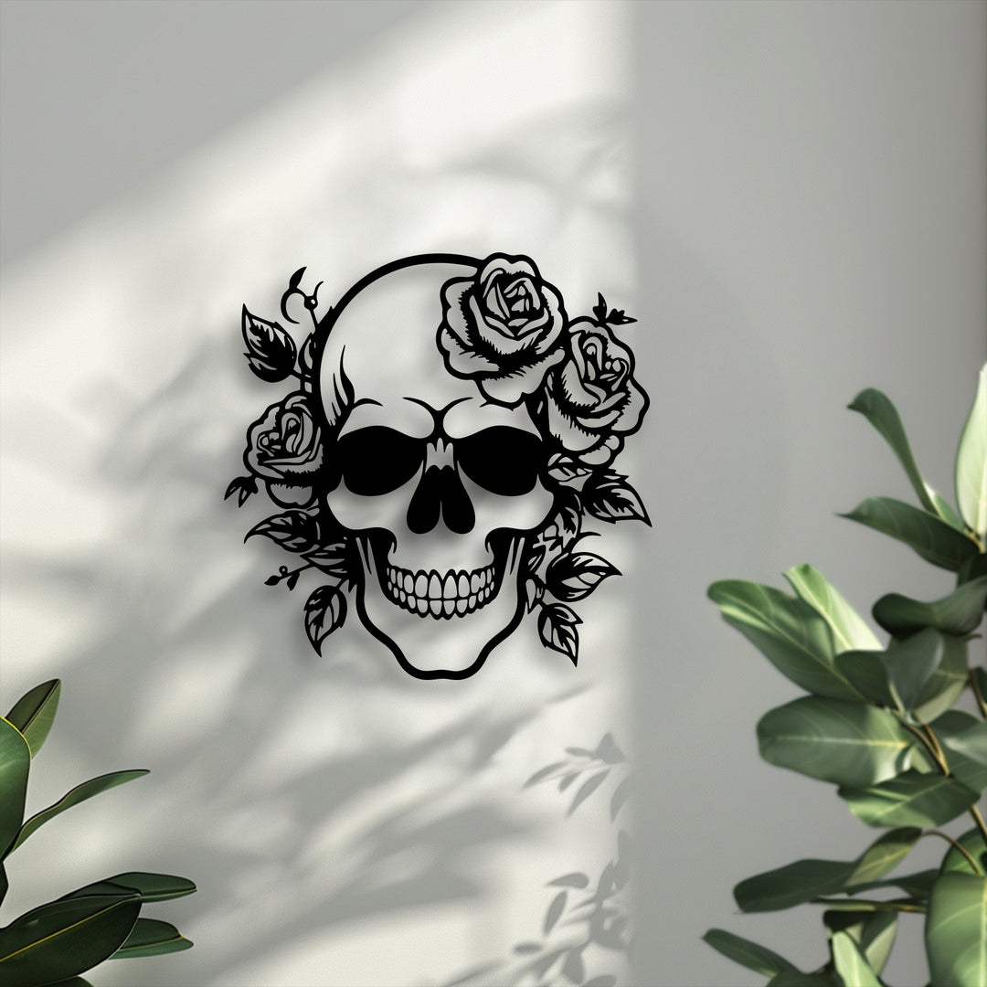 The smooth, matte black floral skull decoration wall art is mounted on a subtly textured white wall, illuminated by soft shadows.