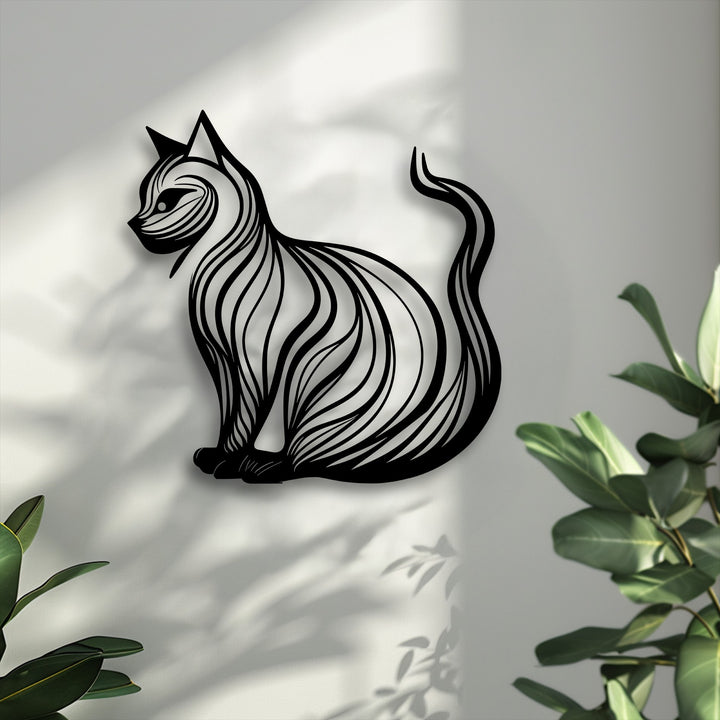 The bright, textured background, featuring dappled light and plant shadows, enhances the elegant cat silhouette metal art for wall.