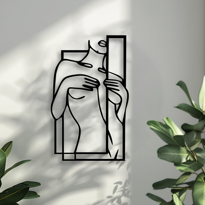 The focal point highlights the minimalist female line art metal wall decor, intricately framed with geometric lines against a light wall.