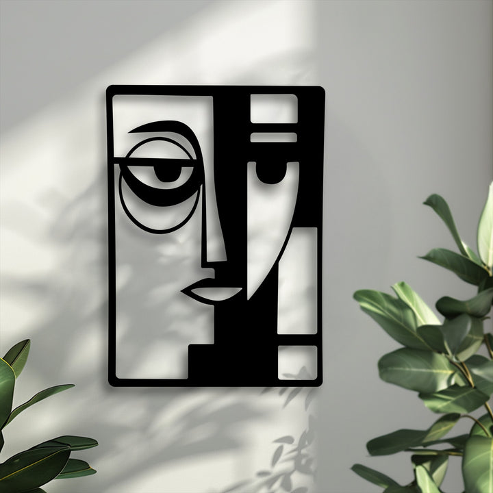 The darkest area, a sleek black metal decoration wall art, displays an abstract dual face with bold, geometric lines.