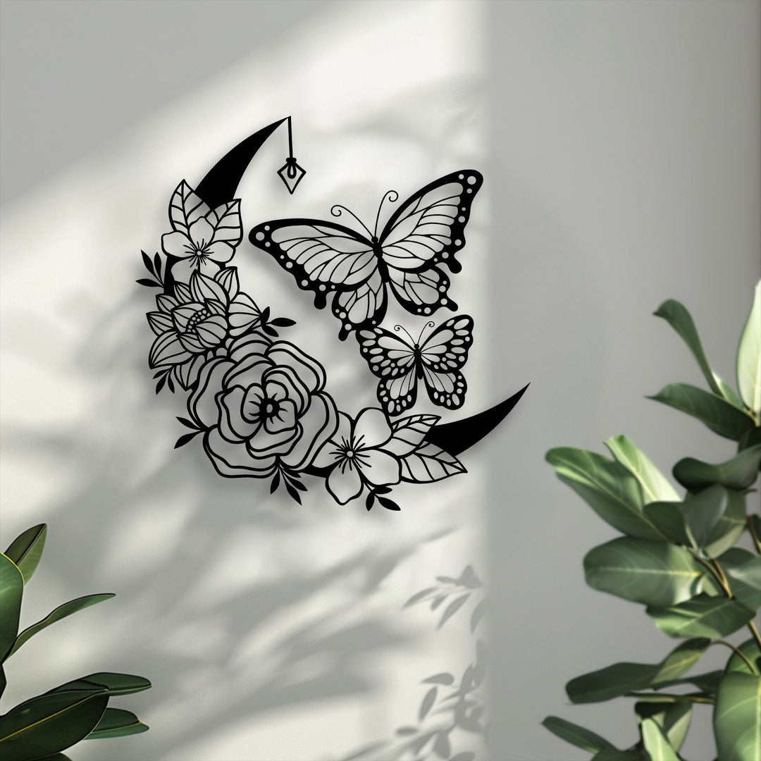 The elegant crescent moon and butterfly shapes form a striking piece of decorative metal art, casting intricate shadows.