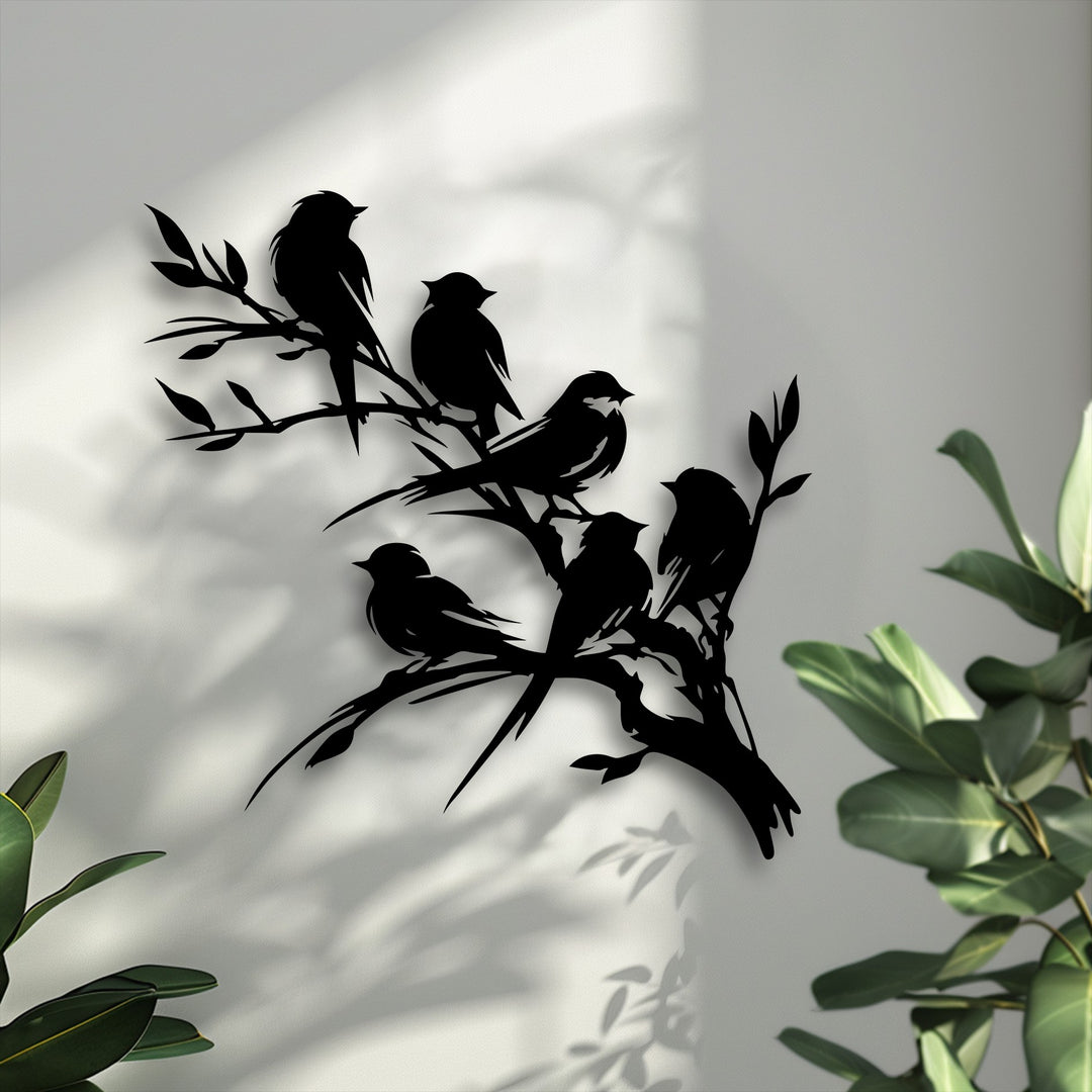 A subtle textured surface beautifully enhances the smooth, unique metal wall art depicting birds on a branch.