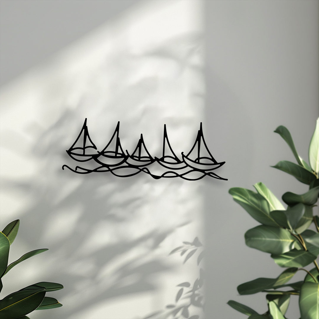 The darkest area prominently features the minimal boat line metal artwork of five black sailboats navigating fluid waves.