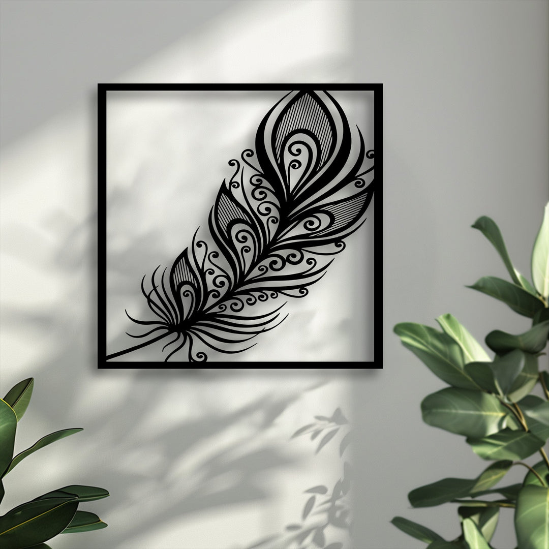 An elegant, black ornate feather decoration wall art crafted from metal, featuring intricate swirl details within a square frame.