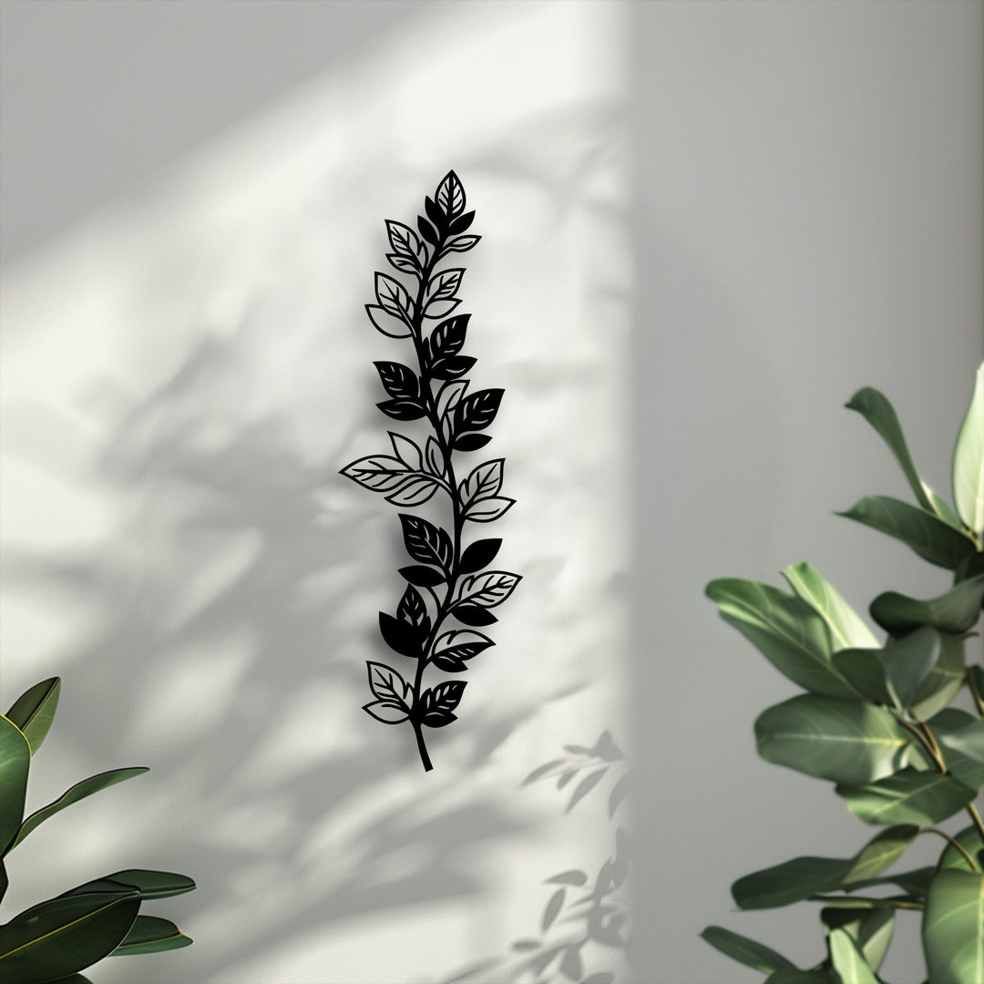 The sleek matte black finish of this botanical leaf branch metal wall decor stands out, offering a modern and elegant vertical nature design.