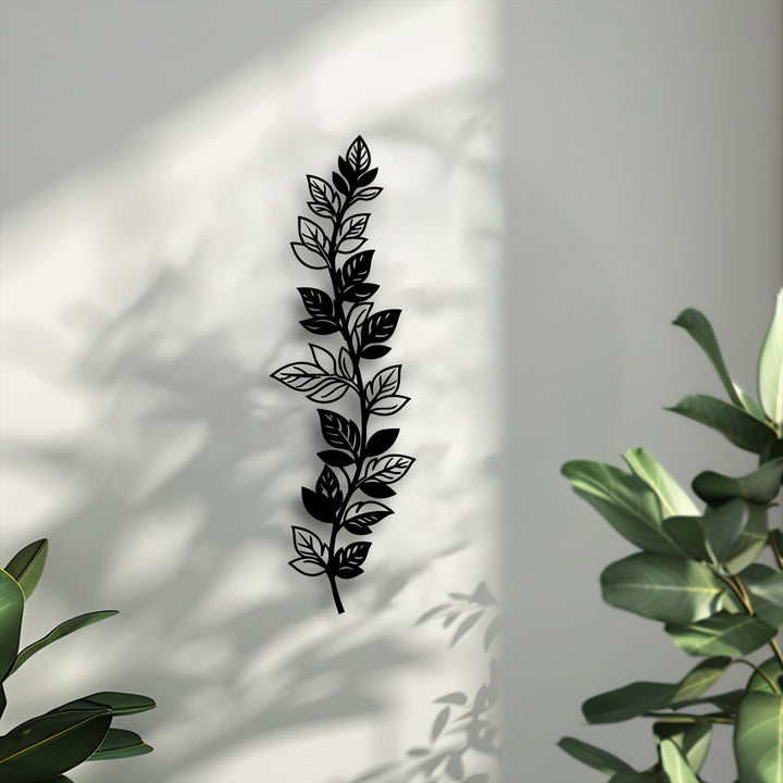 The sleek matte black finish of this botanical leaf branch metal wall decor stands out, offering a modern and elegant vertical nature design.