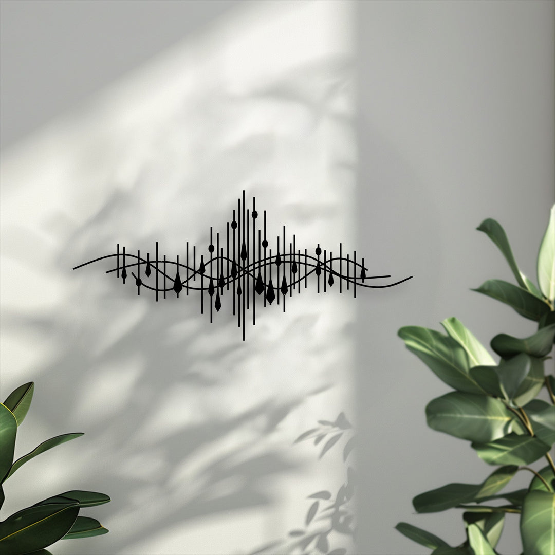 The stark color contrast of the black abstract soundwave decorative metal art pops against the bright white wall, enhanced by natural lighting.