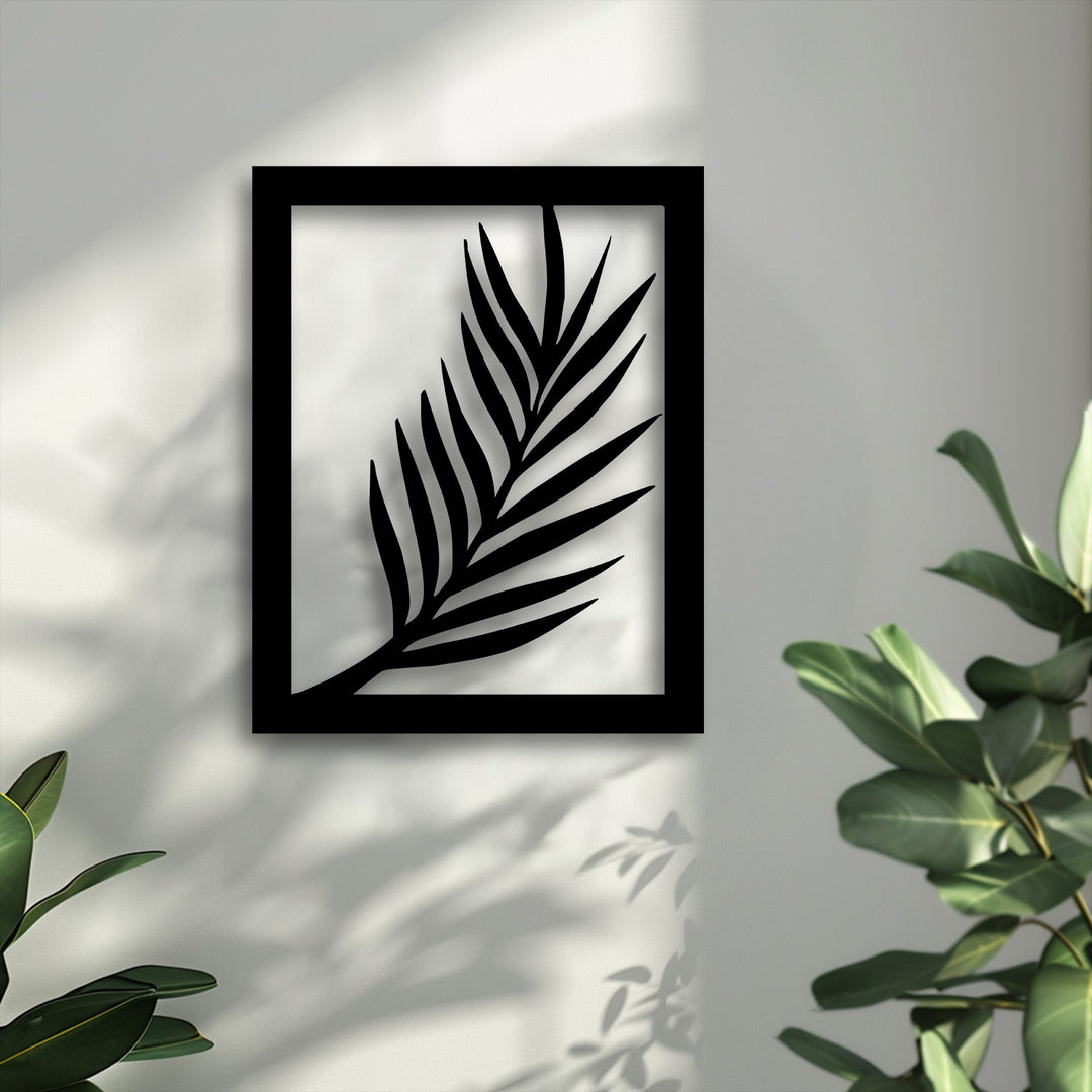 The organic forms of a bold black palm leaf silhouette, modern botanical metal artwork, cast elegant shadows on a sunlit textured wall.