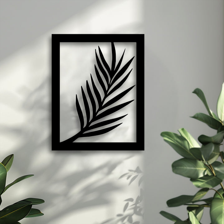 The organic forms of a bold black palm leaf silhouette, modern botanical metal artwork, cast elegant shadows on a sunlit textured wall.