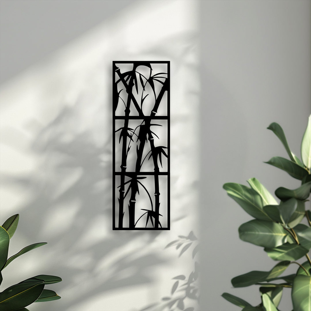 High color contrast between the sleek black minimalist Zen bamboo decorative metal art and the softly lit, textured off-white wall.