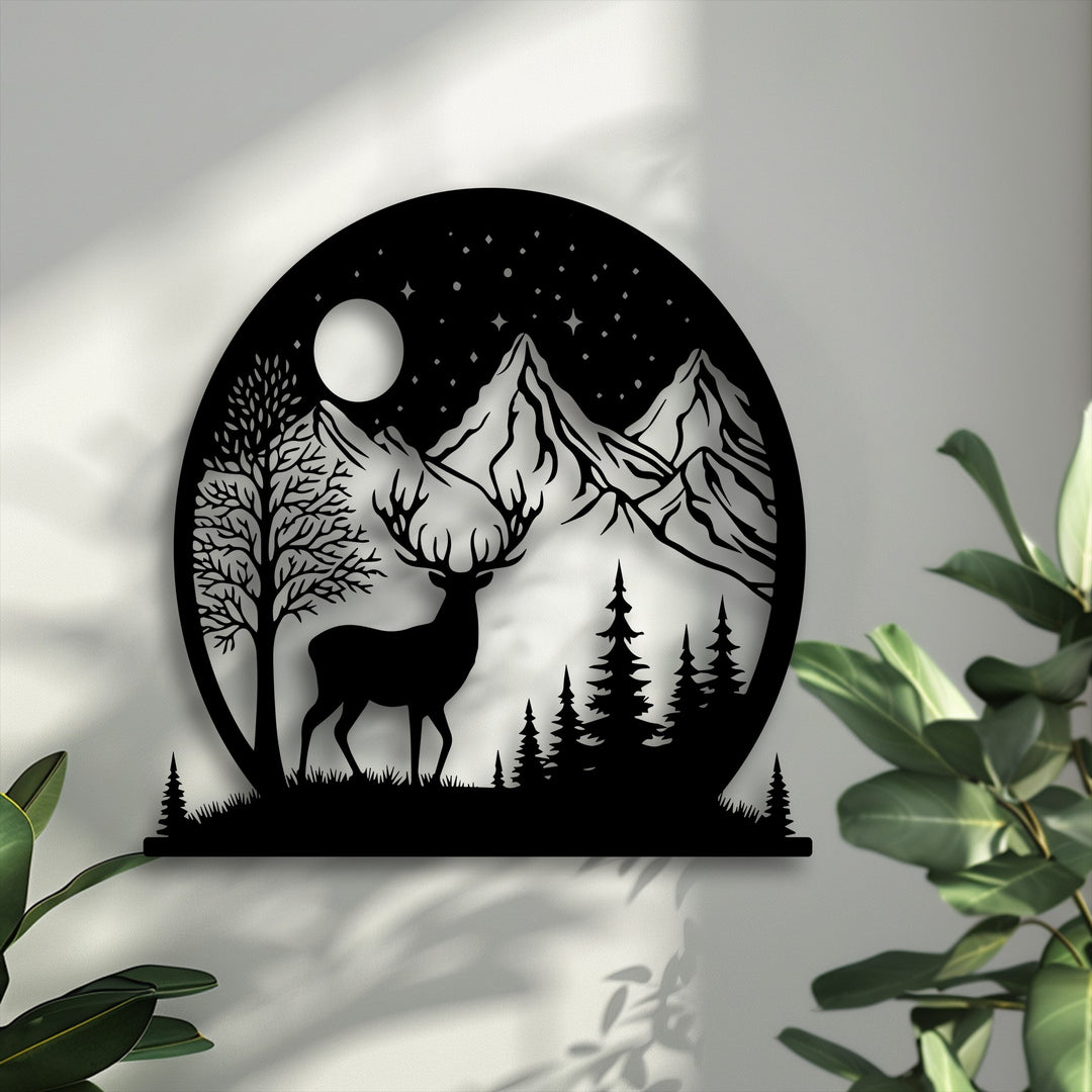 A layered metal artwork displays the moonlit wilderness with a majestic deer silhouetted against mountains and a starry sky, showing distinct depth.