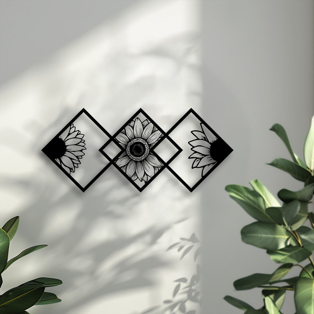 Three black geometric frames, resembling diamonds, form striking metal art for wall, each precisely encapsulating a stylized sunflower design.