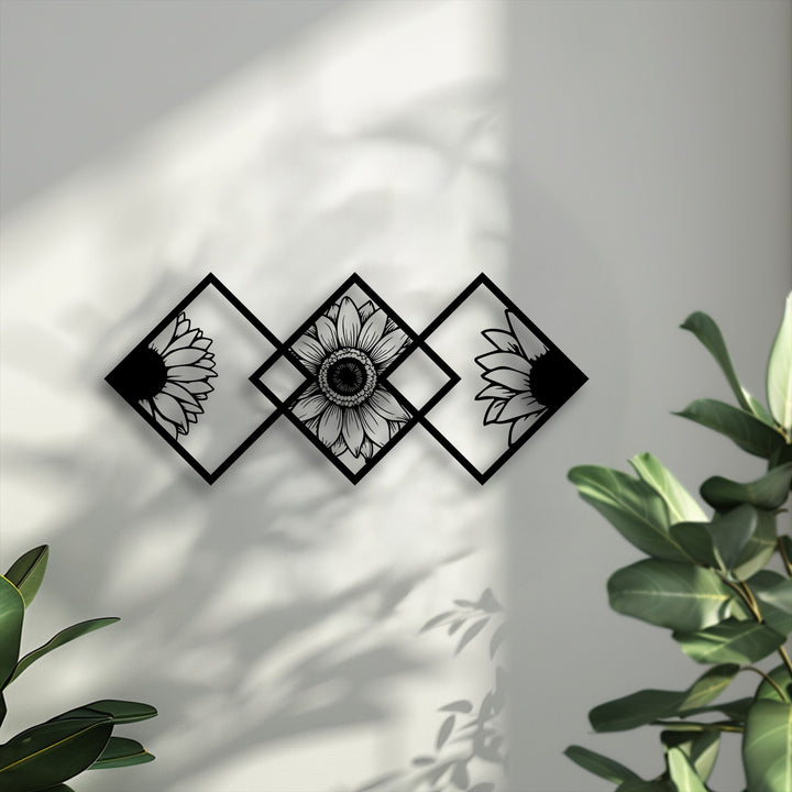 Three black geometric frames, resembling diamonds, form striking metal art for wall, each precisely encapsulating a stylized sunflower design.