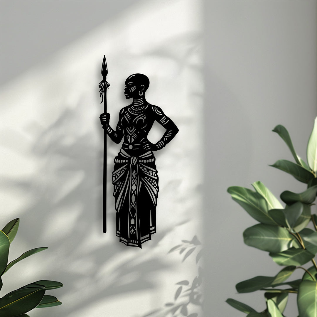 The crisp edges of the decorative metal art outline a powerful African tribal warrior with a spear, casting distinct shadows on the light wall.