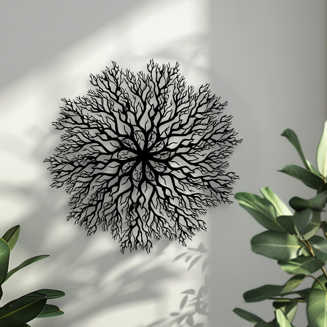 The intricate, laser-cut edges and borders of the black tree roots mandala unique metal wall art create delicate shadows on the wall.