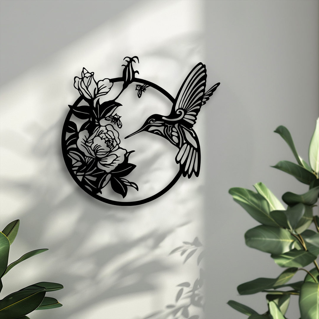 Pale grey provides a serene backdrop for the intricate black hummingbird and blooming flowers metal wall decor, casting soft artistic shadows.